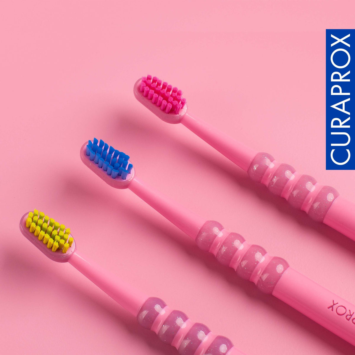 Curaprox baby toothbrushes in blue, pink and turquoise