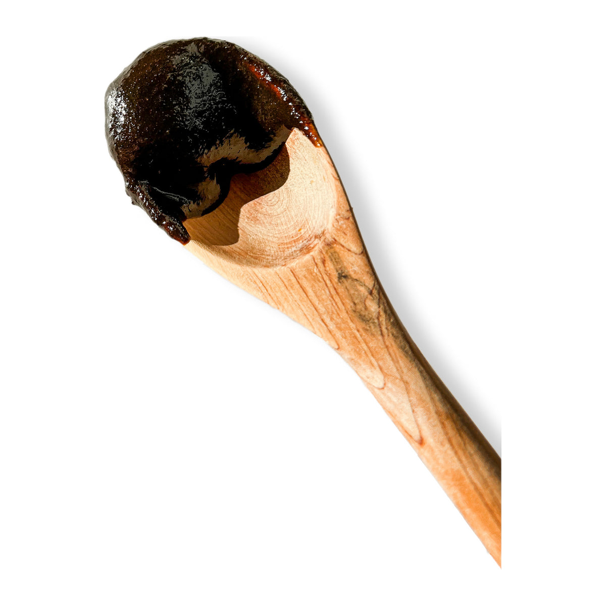 Amla Plex herbal jam on a wooden spoon