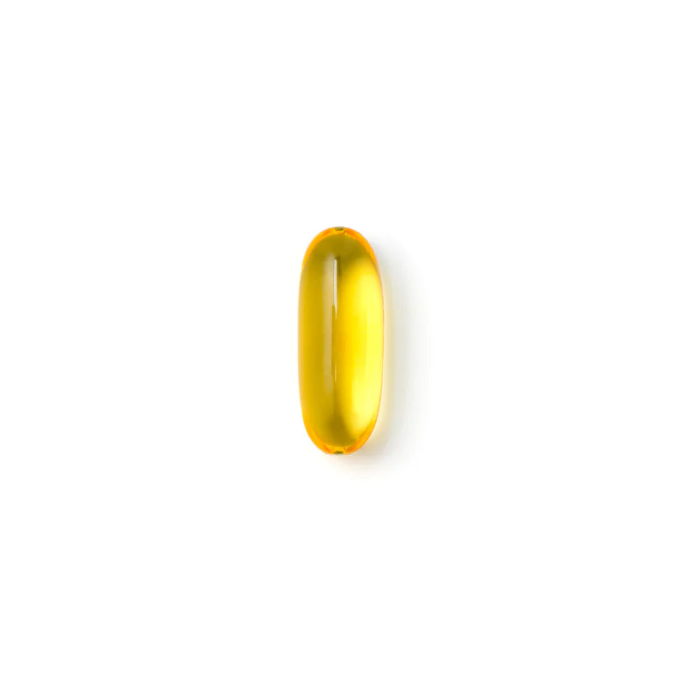 A single golden Metagenics SPM Active soft capsule on a white background