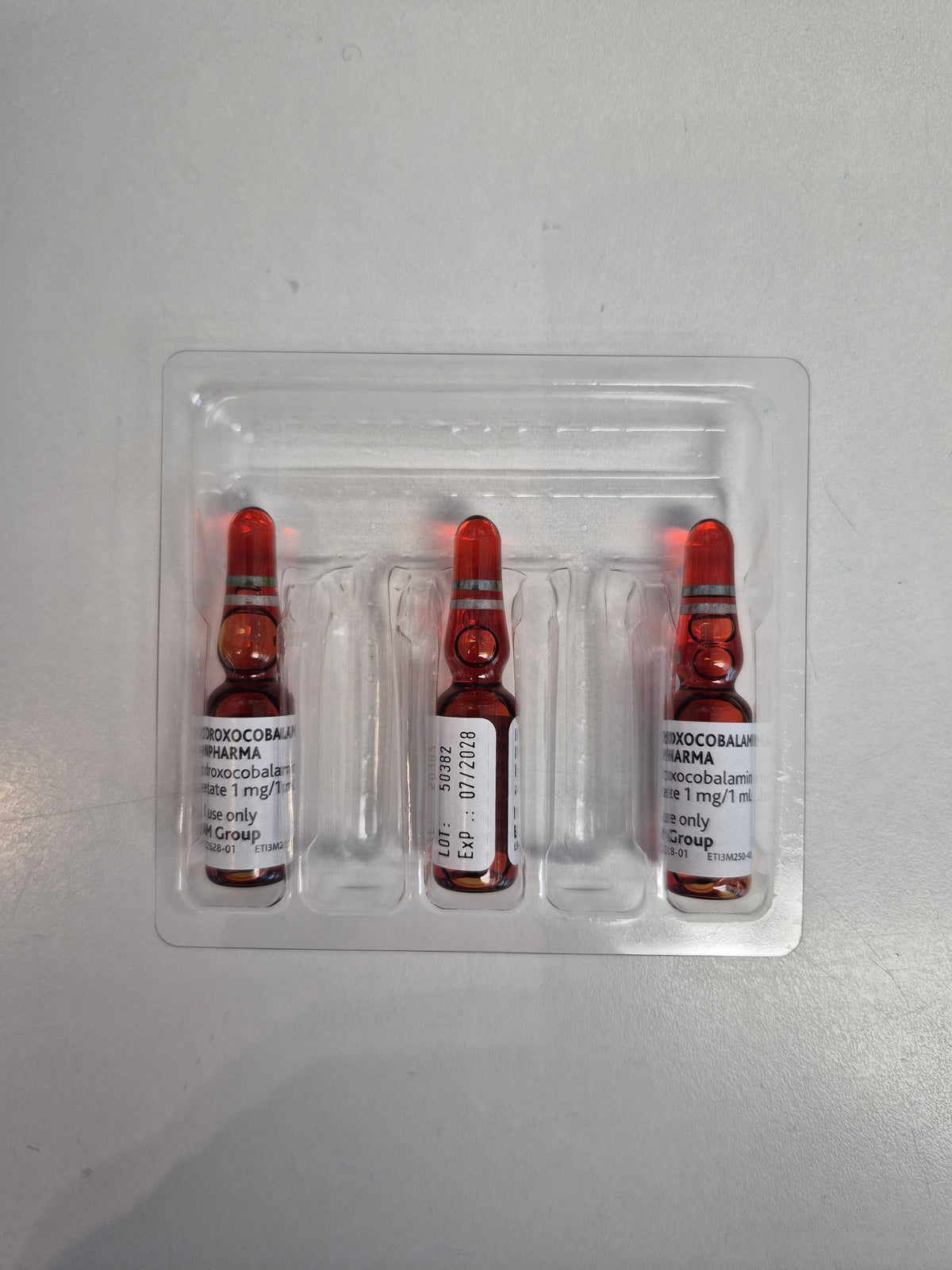 Three vials of B12 in a clear plastic packaging 