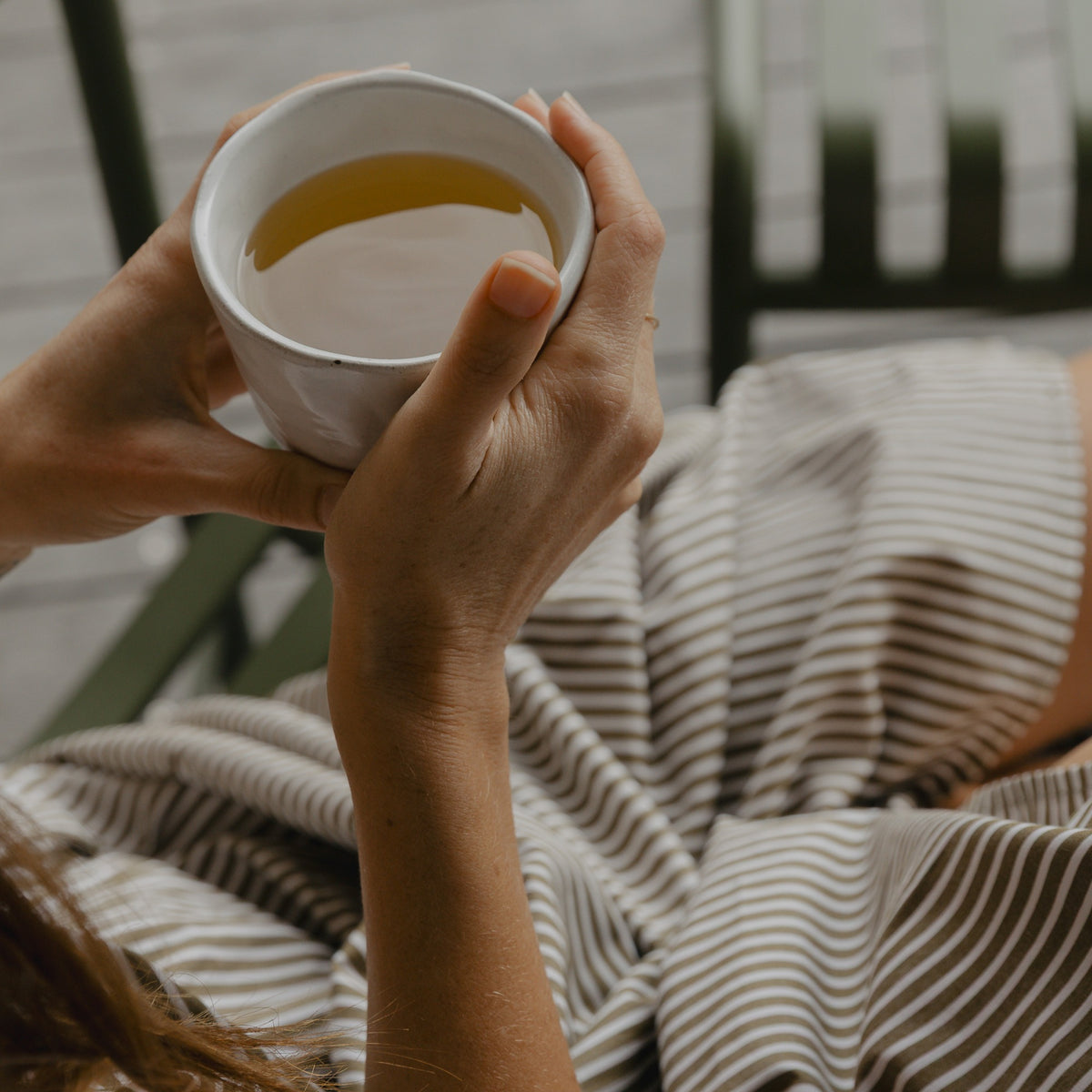 A mug of Peppermint Tea held in both hands