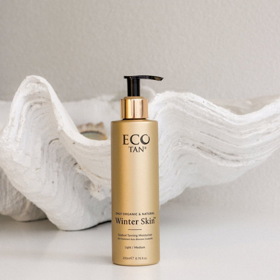 Eco Tan Winter Skin bottle styled beside a shell