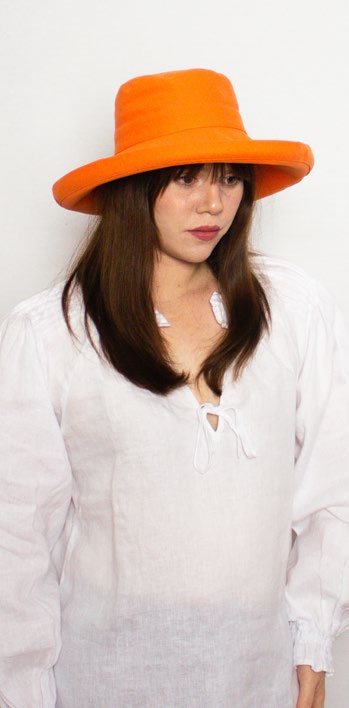 Female model wearing Ladies Hat Cove Orange