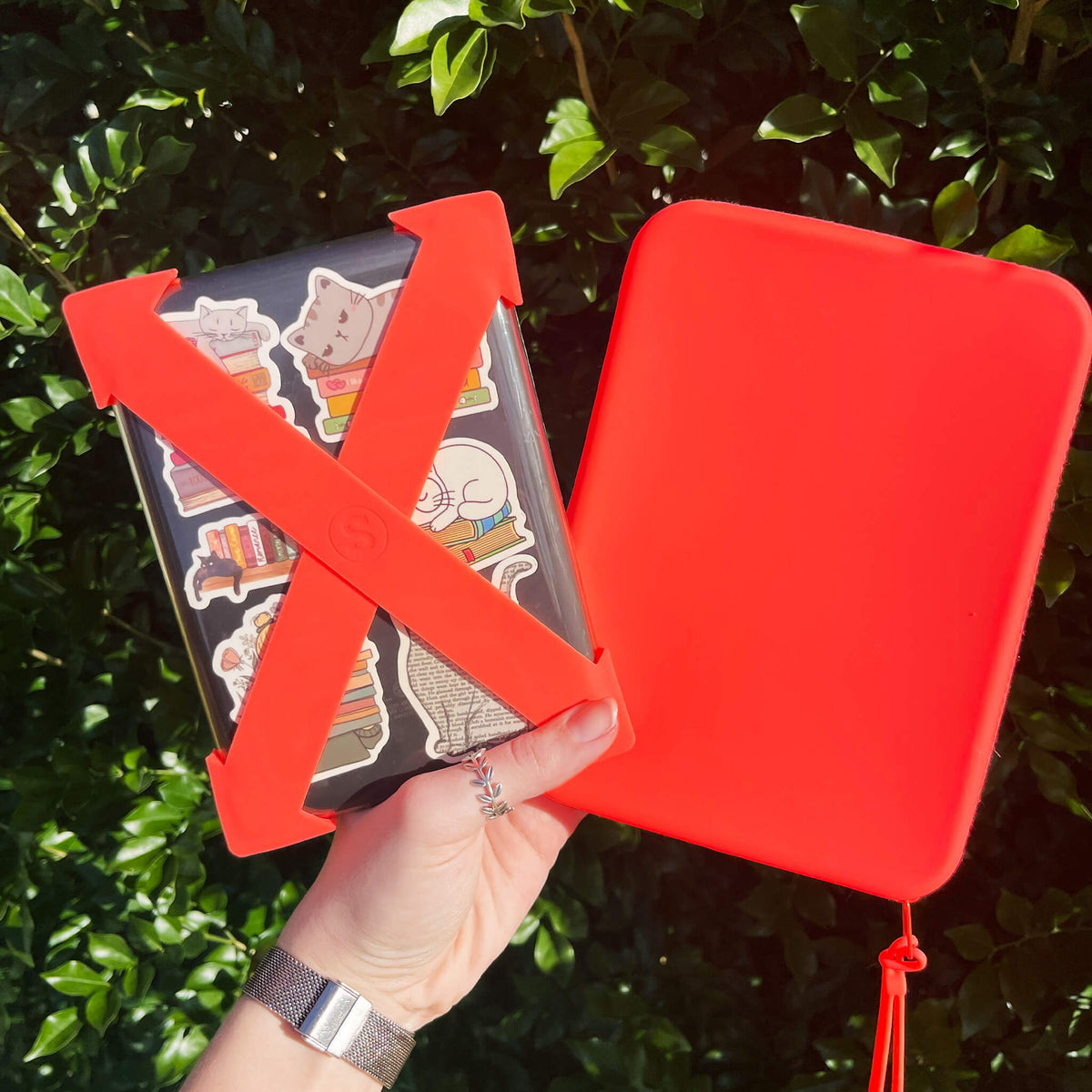 Strapsicle straps in Neon Flame in use while reading