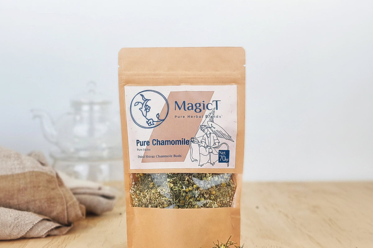 Bag of MagicT Pure Chamomile on a wooden surface with chamomile flowers spilling out.