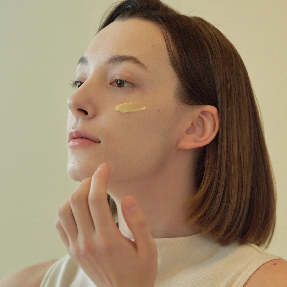 Image of lady applying Revive Eye Serum: Ginseng + Retinol 30ml