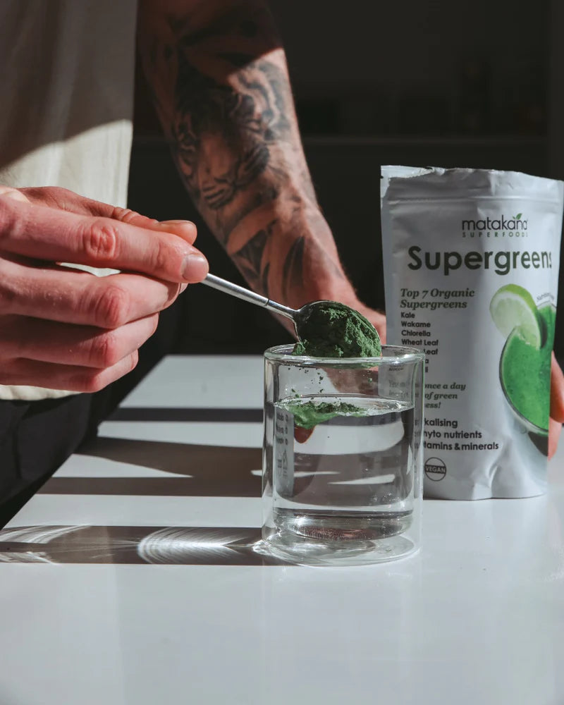 Image of SuperGreens Top 7 Super Greens being stirred into glass