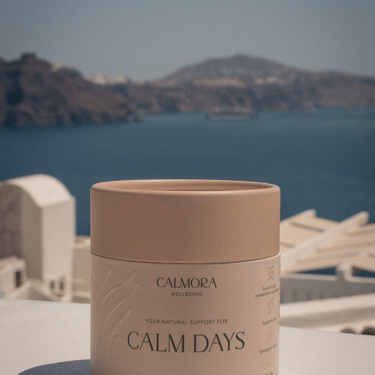 Calmora Wellbeing Calm Days tub on a table with a harbour view behind it