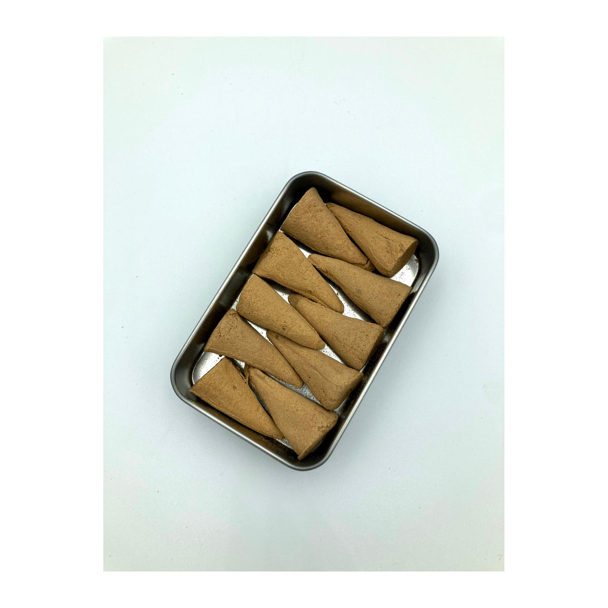 Pure Sandalwood Incense Cones 10 Pack incense burning on a dish