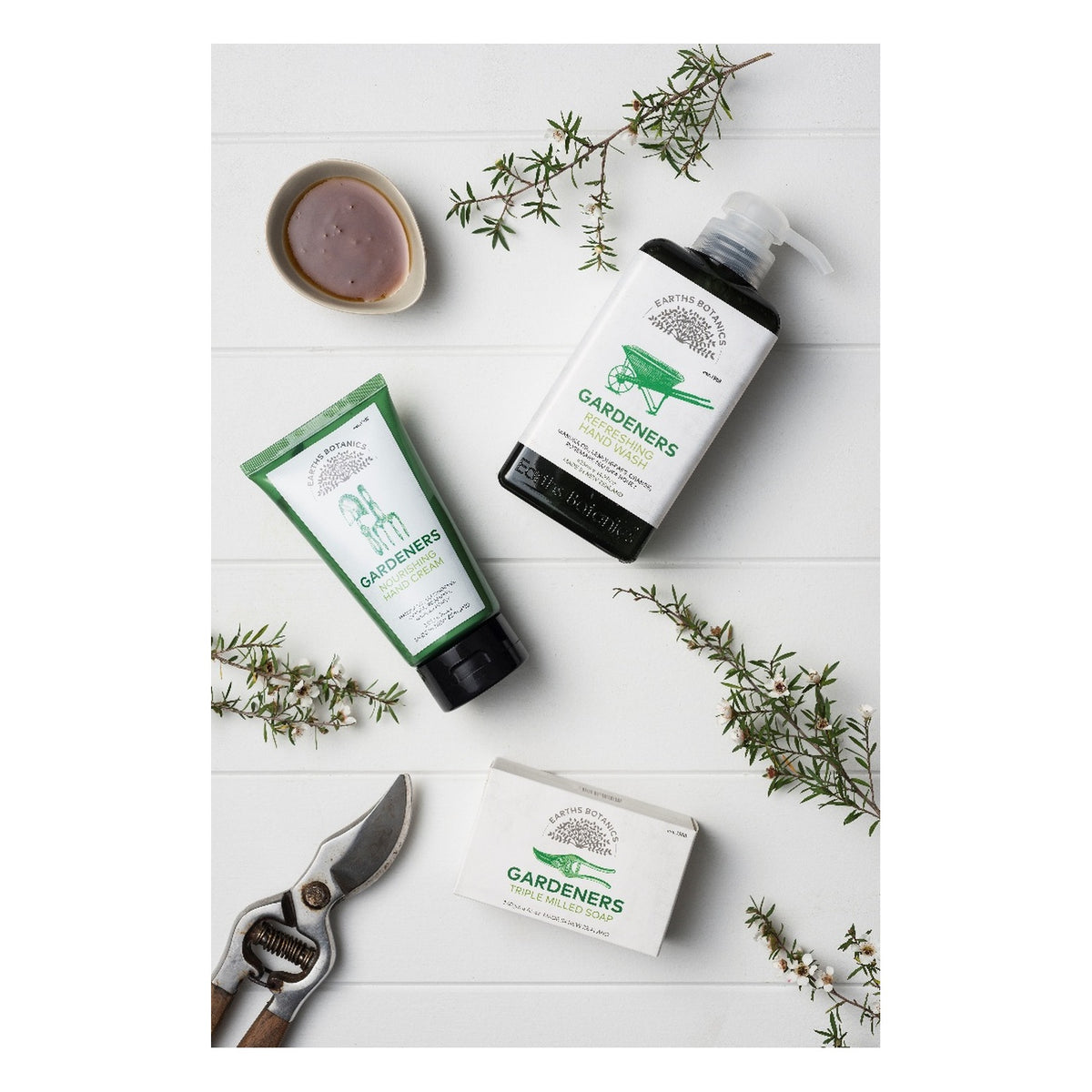 The Earths Botanics Gardeners range photographed with rosemary and secateurs