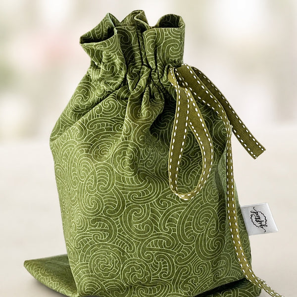 Green Koru handmade fabric gift bag by Gifted With Love, shown in all three sizes