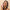Woman with lathered hair holding the Hair Gain shampoo pump bottle