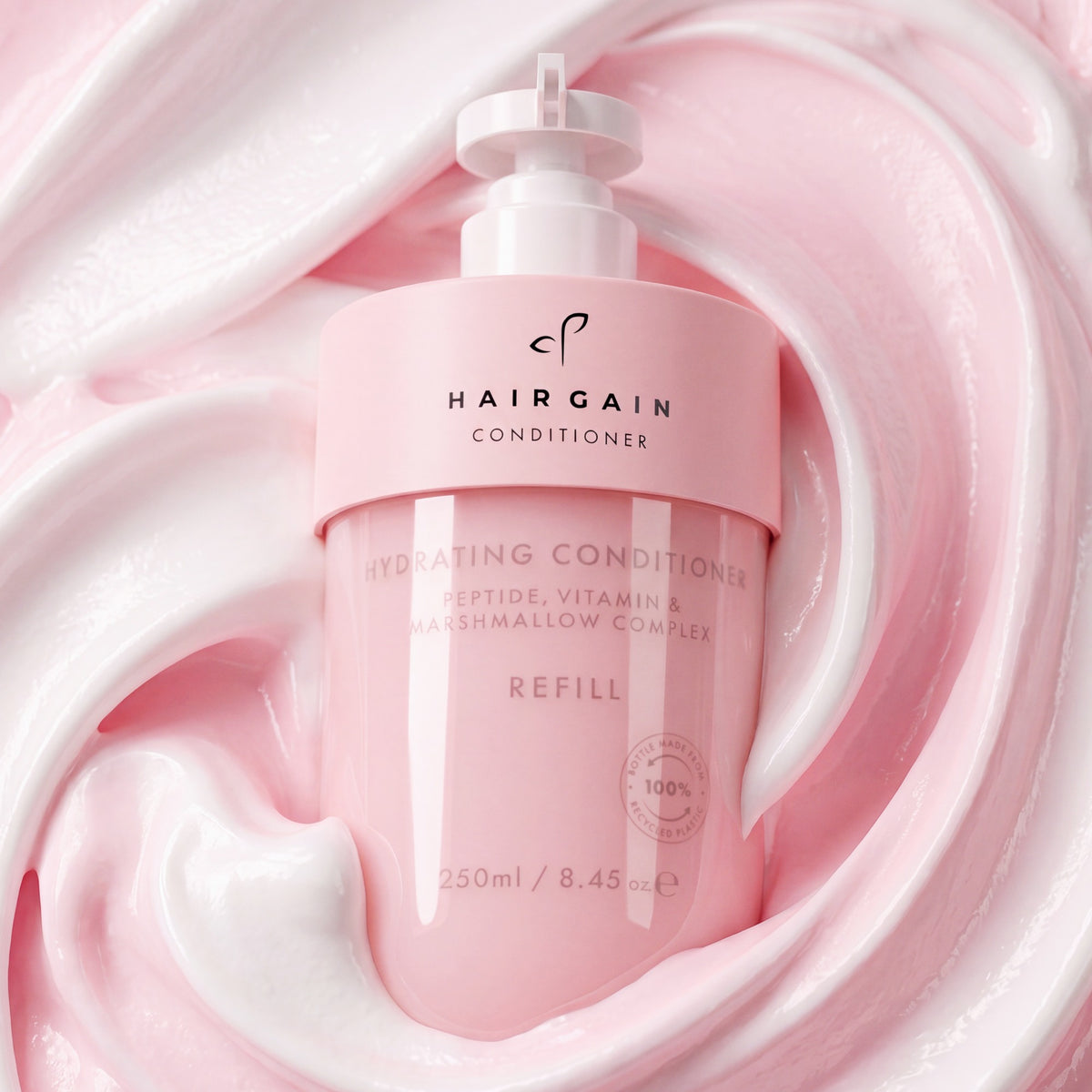 Hair Gain Hydrating Conditioner bottle set in a swirl of pink conditioner
