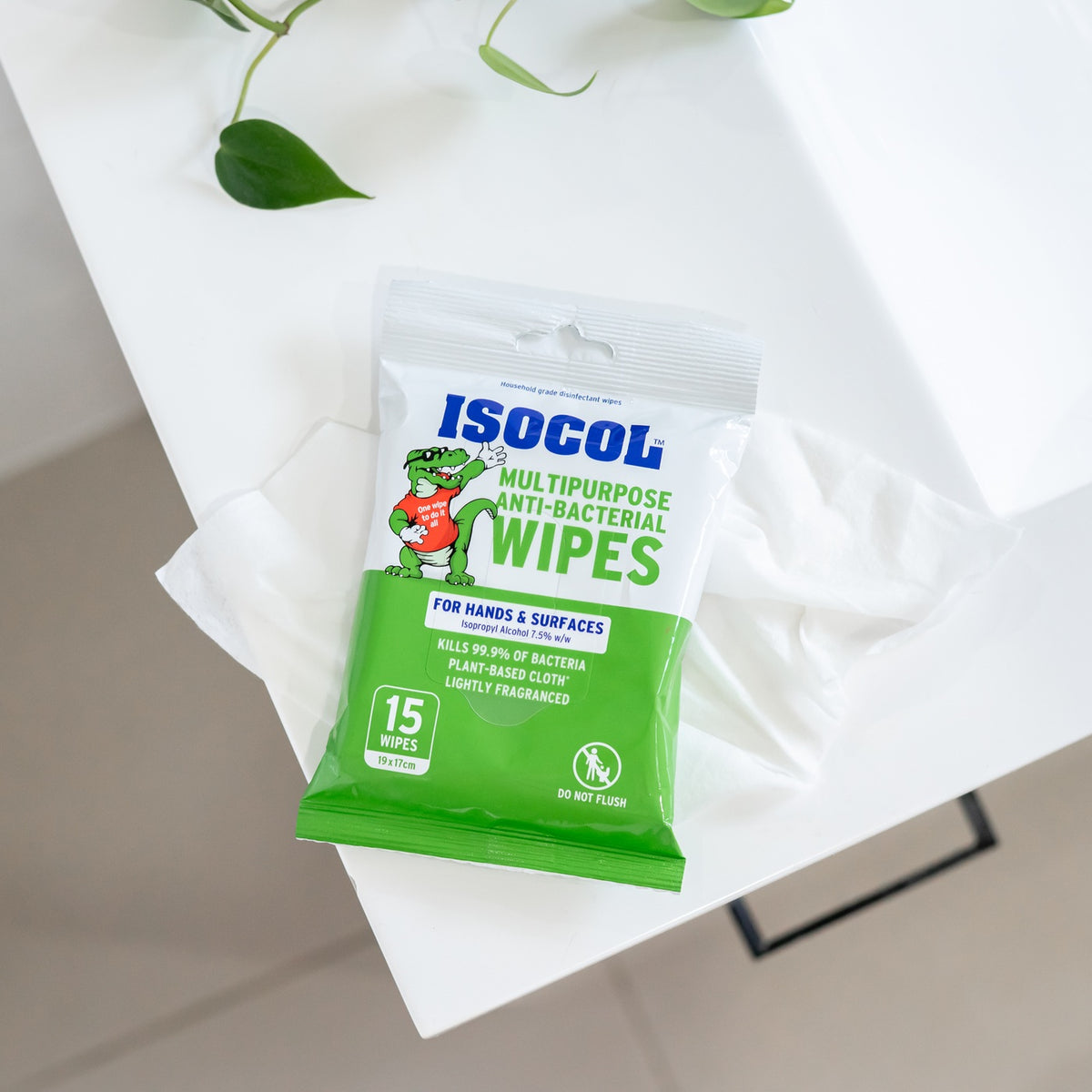The Isocol anti-bacterial wipes pack open on a white table with a wipe pulled out