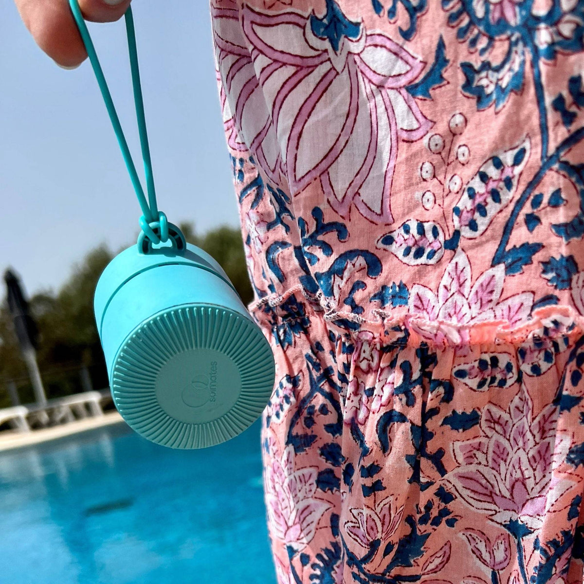 A Solmates applicator tethered to a bag beside a pool