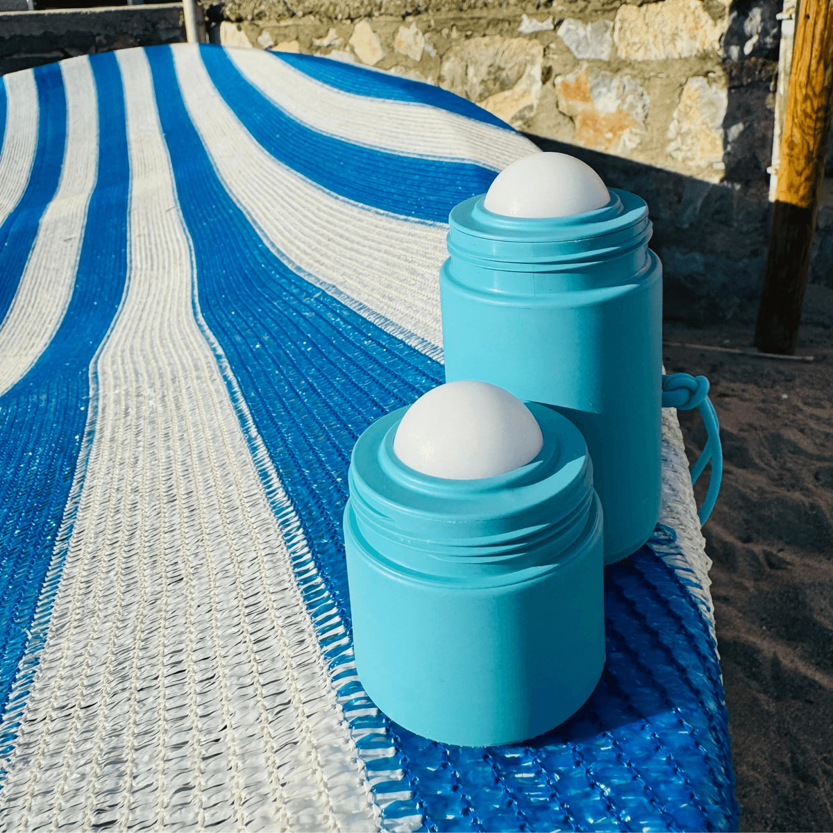 A Solmates applicator on the tiles beside a pool
