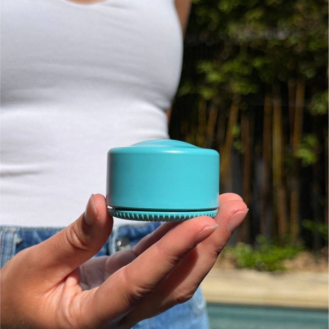 A Solmates refillable pot held in one hand