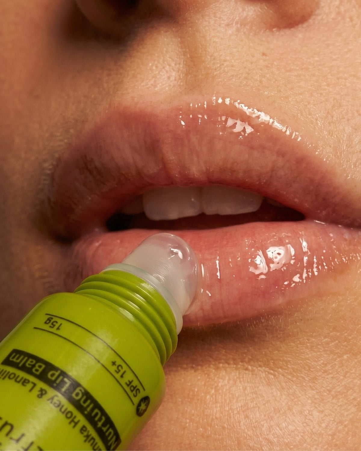 A PoiPoi lip balm tube being applied to lips