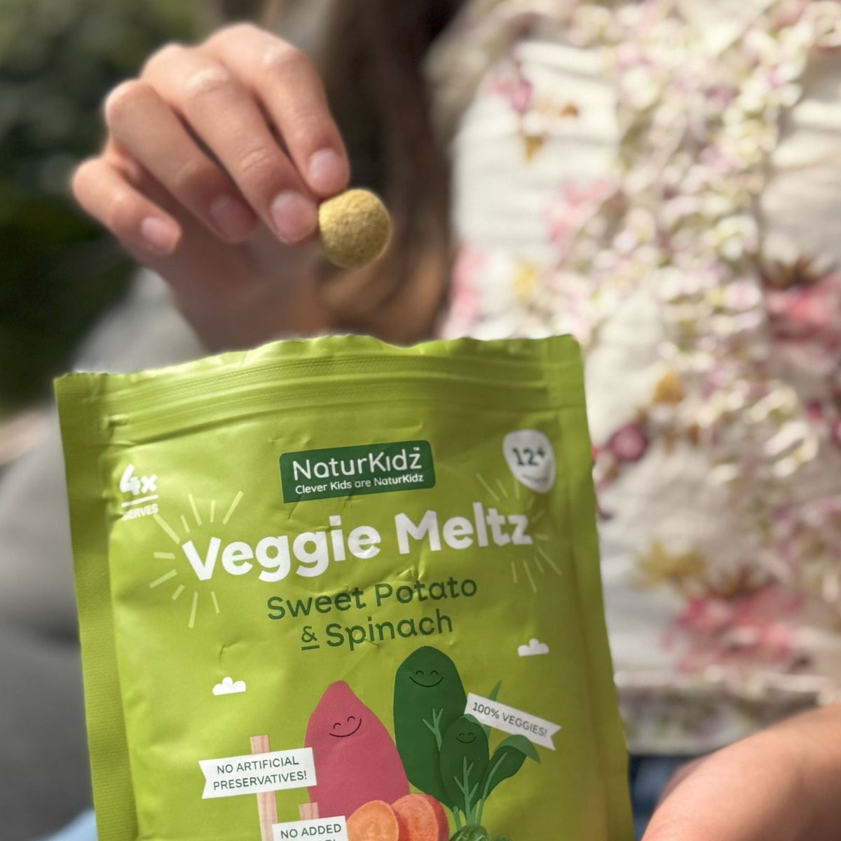 NaturKidz Veggie Meltz Sweet Potato & Spinach, being eaten