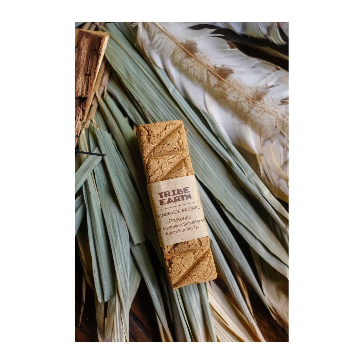 Presence Incense Planks - Sandalwood & Australian Vetiver incense burning, with the botanicals it is made from
