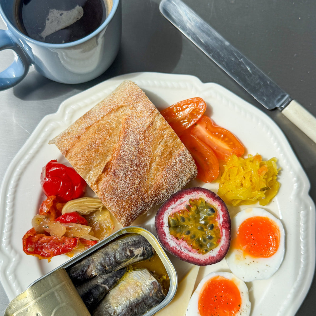 Sardines served on a breakfast plate with eggs, tomatoes and toast