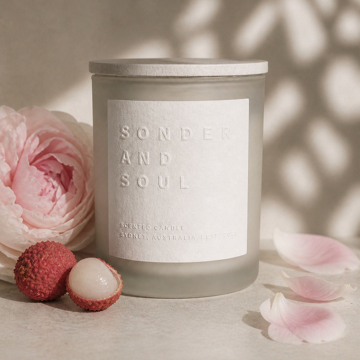 Lychee Peony soy candle by Sonder and Soul, styled with the fragrance notes