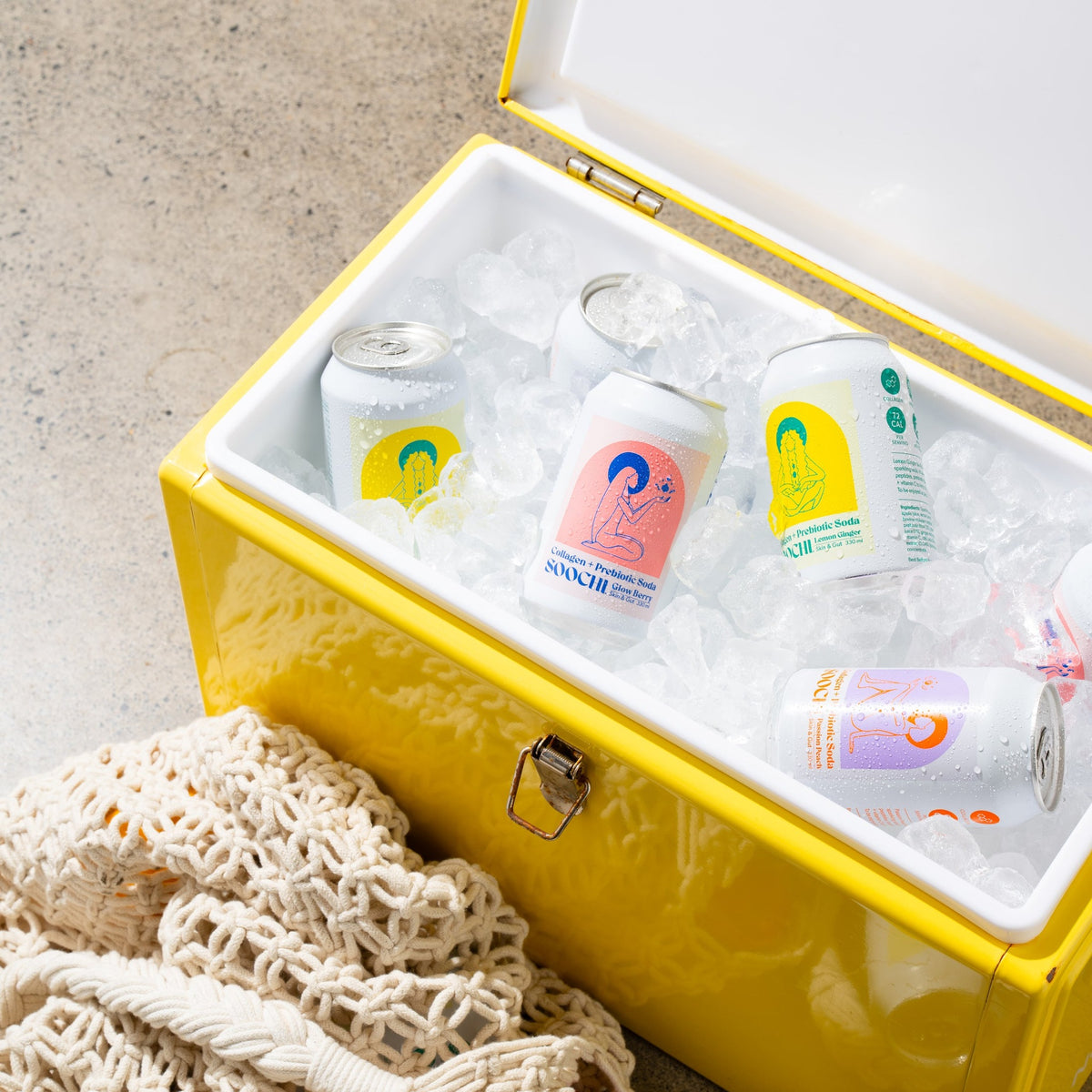 Soochi cans on ice in a yellow cooler