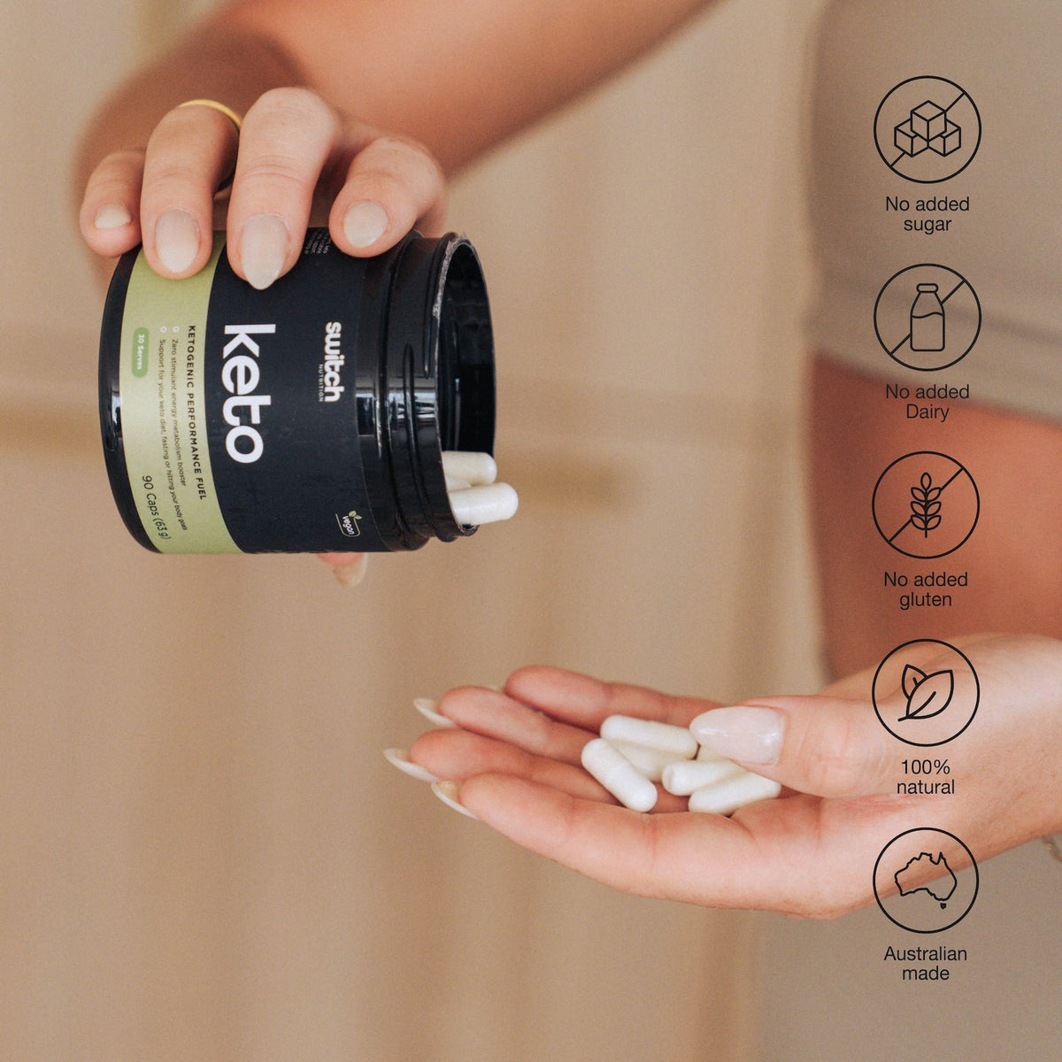 Switch Nutrition Keto BHB, current black tub with olive green keto label, tipped to pour capsules into a hand, with no added sugar, dairy free, gluten free, natural and Australian made icons